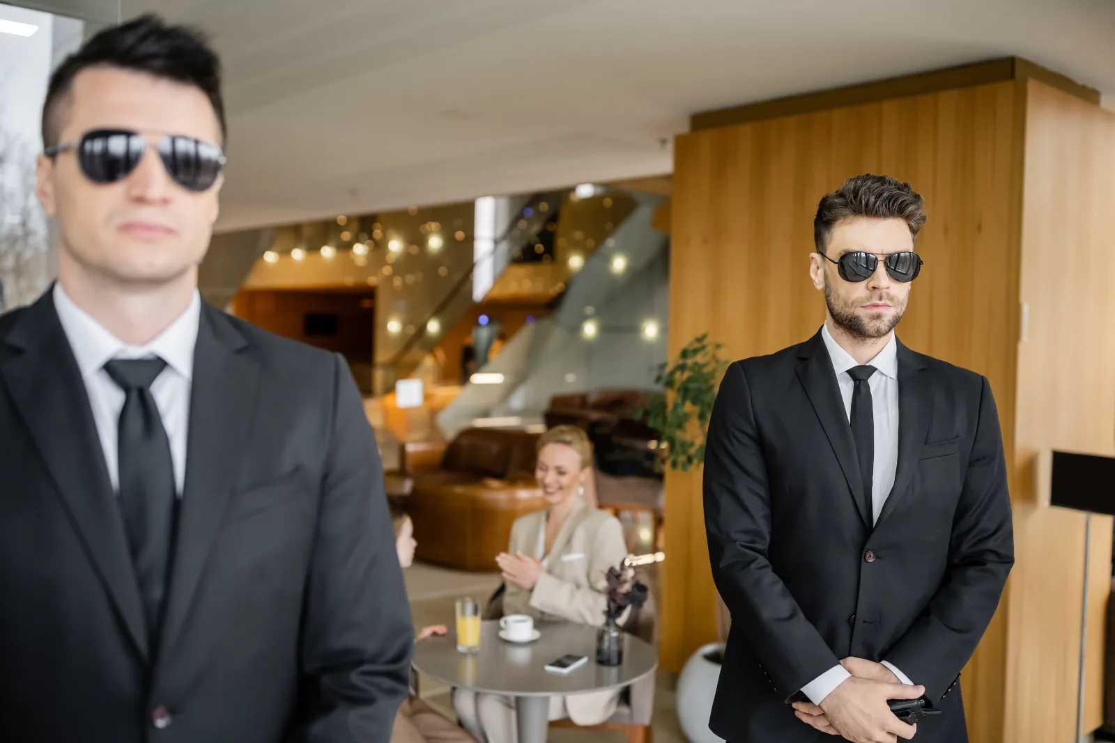 Executive protection agents in a hotel foyer