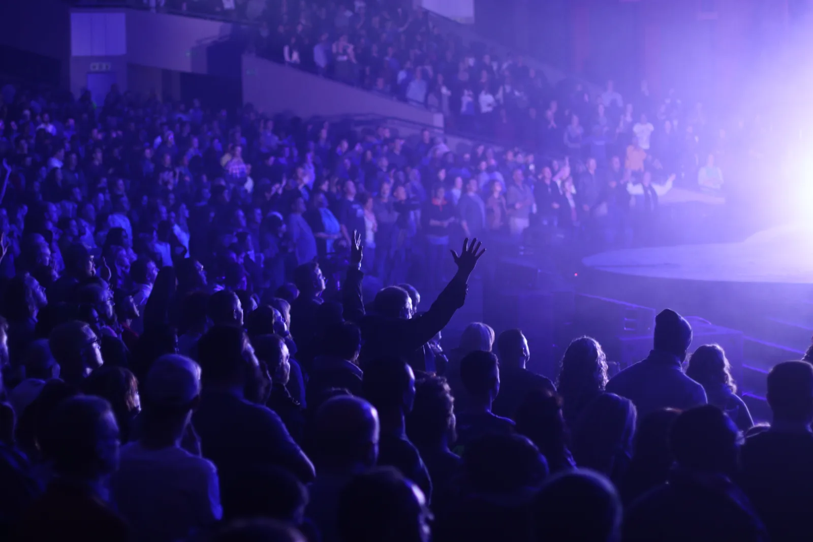 Worshippers with hands raised at a Dallas–Fort Worth church service